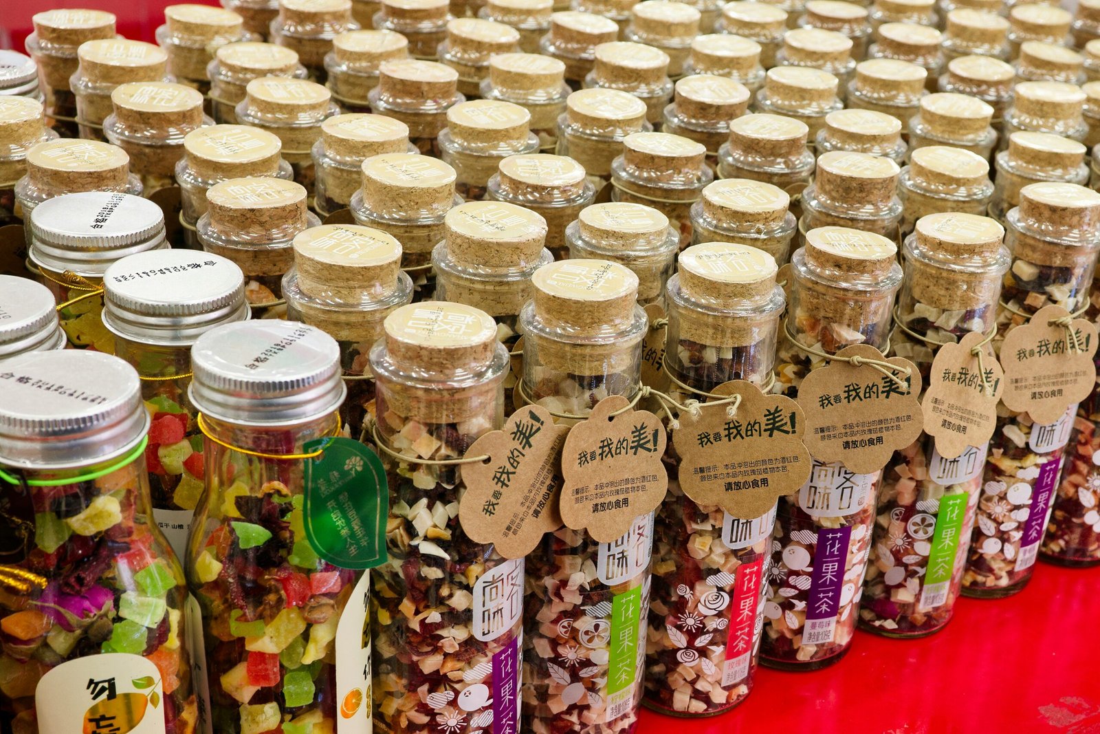 A table topped with lots of jars filled with food